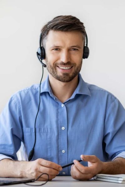 portrait-of-smiling-male-customer-service-operator-2022-12-16-08-34-45-utc-min.jpg